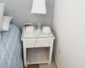 Wicker nightstand with glass top; table lamp