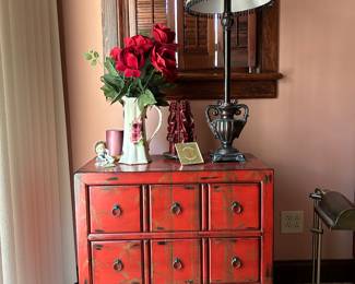 An Asian-inspired chest of drawers features a faux apothecary front. It actually has three drawers that glide open and close. 