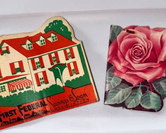 These colorful folders each hold sewing needles. Notice the house folder is an advertisement for First Federal Savings & Loan Association. 