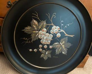 A classic grape design adorns a large tray, about 20-inch diameter, suitable for use or to hang on a wall. 