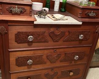 This unusual dresser features decorative overlays and hankie drawers. 