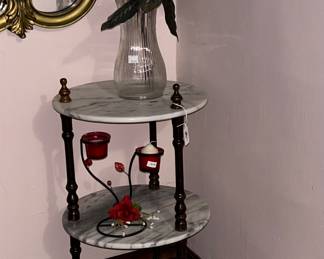 A tiered marble table has a small footprint with a big impression. 