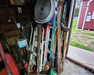 Several ladders of all sizes, wheelbarrow