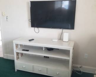 Flat screen TV; white entertainment console