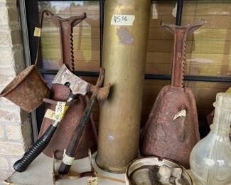 Old brass tank shell casing and antique jack stands