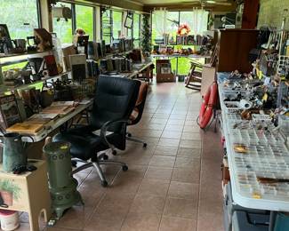THIS LONG BACK PORCH IS LOADED WITH FISHING GEAR AND FISHING BOOKS