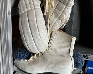 Pair of ladies ice skates and winter gloves