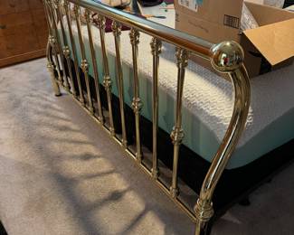 Beautiful lines of the king size brass sleigh bed