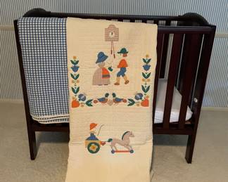 Portable Wooden Crib with Checked Quilt and Appliquéd Children's Quilt