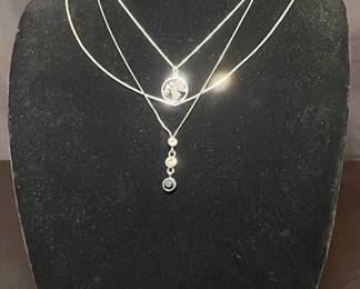 Assorted earrings and silver necklaces