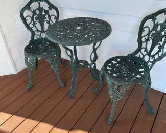 Nice outdoor cafe table and two chairs. Heavy metal. Sturdy. 