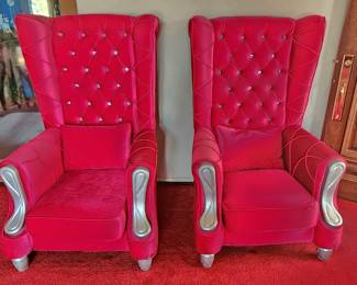 2 red velvet throne chairs with silver accents.