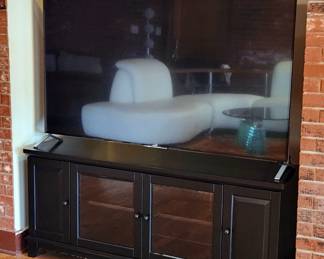 65" Sony TV (works). Black media cabinet and it does have some edgewear.