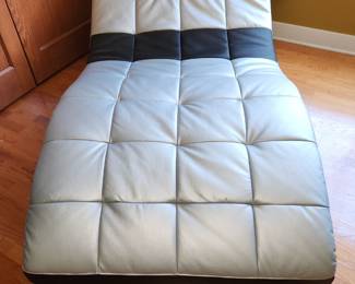 Silver and black faux leather floor chaise lounge chair.