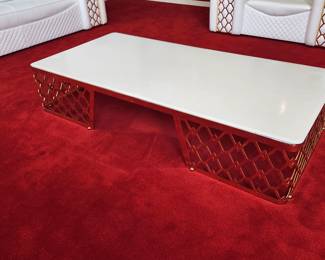Formenti coffee table with gold base and white top. Tops has some markings.