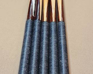 Brown and red pool cues