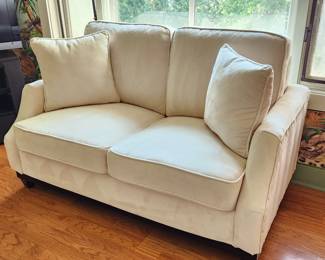2 seat off white sofa with nailhead side arm.