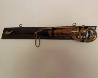 Spear arrow with boat line on wood stand