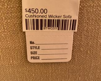 Cushioned wicker sofa