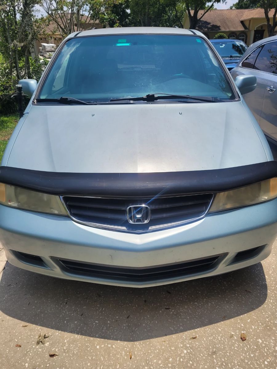 2004 Honda Odyssey with 122,000 miles. Runs good, A/C works, some slight body damage.