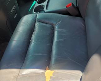 Driver seat has a small tear in the seat