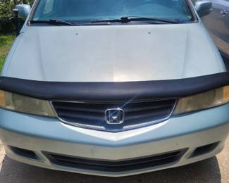 2004 Honda Odyssey with 122,000 miles. Runs good, A/C works, some slight body damage.