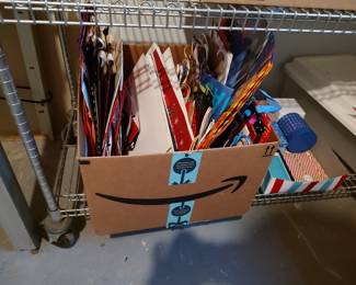 Two boxes of wrapping paper and a box of assorted holiday birthday gift bags $20 for all.