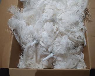 Vase feather topper with LED lights add flowers to dress them up for a wedding.