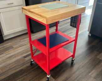 Red Metal Kitchen island w/ wood block top.  Folds away