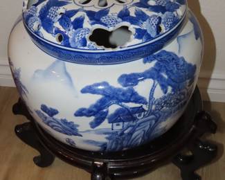 Large covered ginger jar/planter on wooden stand.