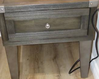 One of two matching end tables with power outlets.