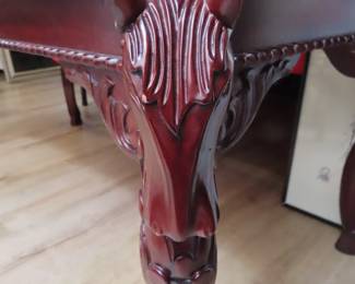 Cherry colored coffee table with corner horse head legs. 