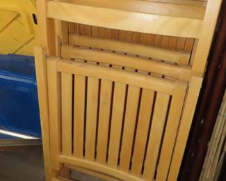 Three folding wooden chairs.