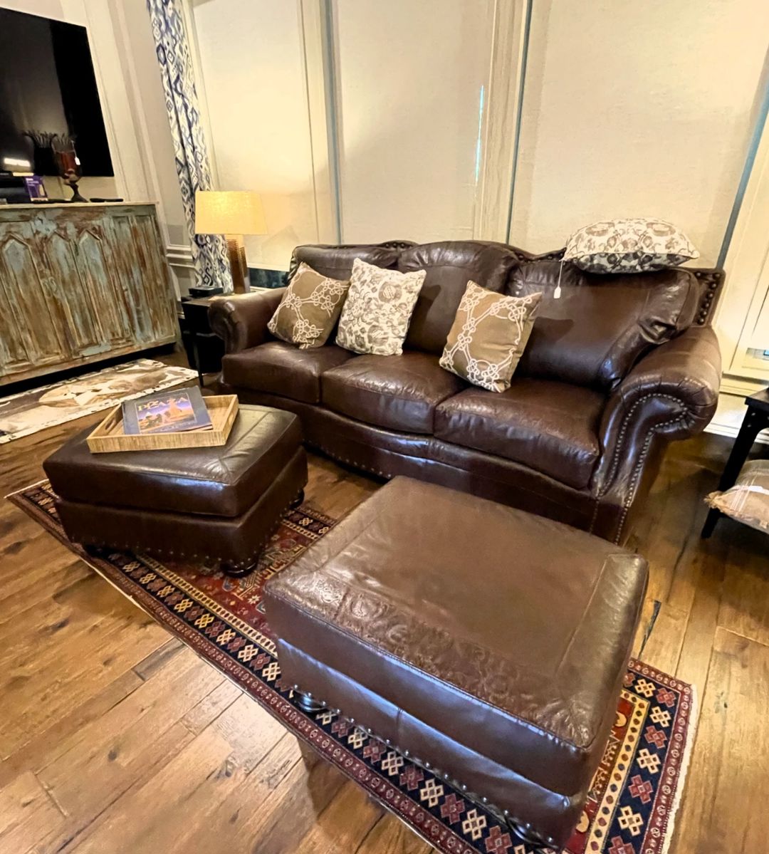 Leather sofa, two overstuffed chairs and two ottomans. 