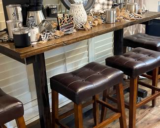 Very unique custom-made industrial table on casters.  Heavy metal frame with wooden top. 
