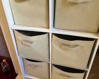 White storage cabinet with canvas storage bins,