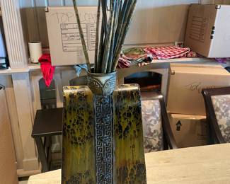 Metal "robe" vase with decorative sticks. 13"w X 6.5"d X 22"h (45"h to top of sticks)
