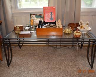 Iron and glass coffee table had matching end tables, games, decor