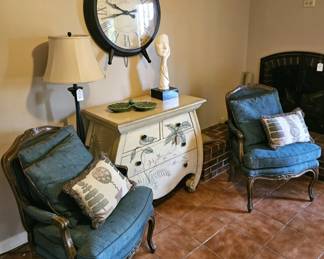 Upholstered armchairs with pillows, painted BOMBAY chest, clock, lamp