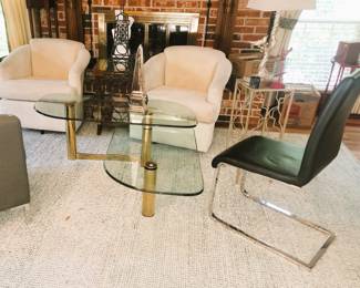 Living room furniture.  Modern brass and glass coffee table, plant stands, lamps and chairs