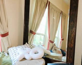 Giant standing mirror, pair of ottomans and throw pillows