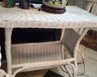 On of three vintage, white wicker tables.