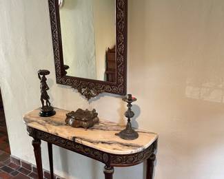 Antique marble topped console table with brass accents and matching mirror, shown with antique brass and copper artwork and accessories