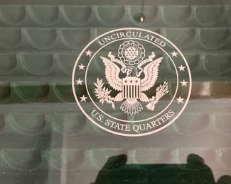 Label on glass on state quarters chest