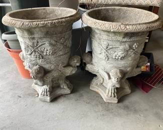 Pair of concrete urns w cherubs