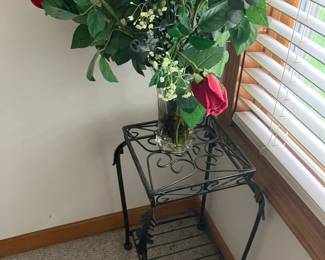 Iron table with bouquet of roses