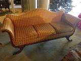 Victorian sofa with brass feet.