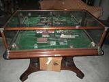 Marklin Z-gage train layout with trains, track & houses. This is encased in glass and is attached to a pedestal.