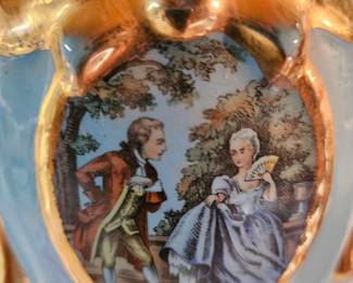 Art on one of a pair of lovely vintage lamps