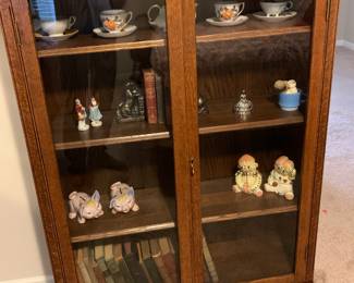 Antique cabinet with key; vintage piggy banks; vintage Raggedy Anne and Andy